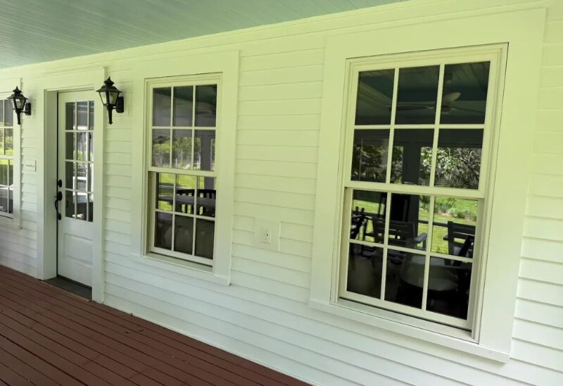White porch with windows and door.