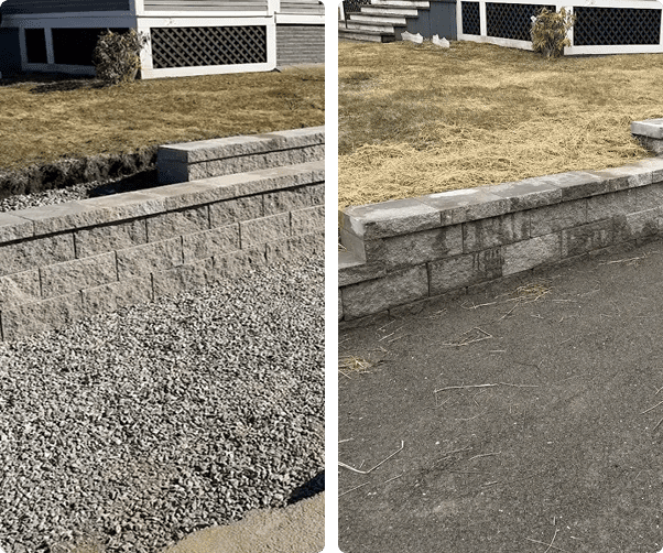 Stone retaining wall with gravel and grass.