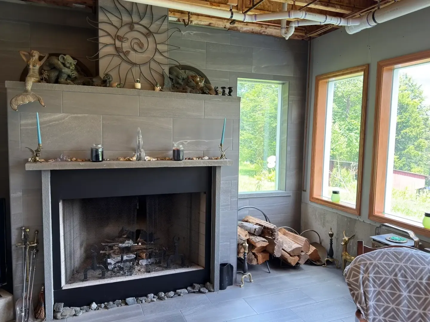 Modern living room with fireplace and windows.