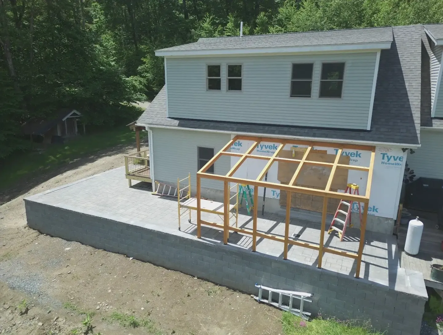 House under construction with patio framing.